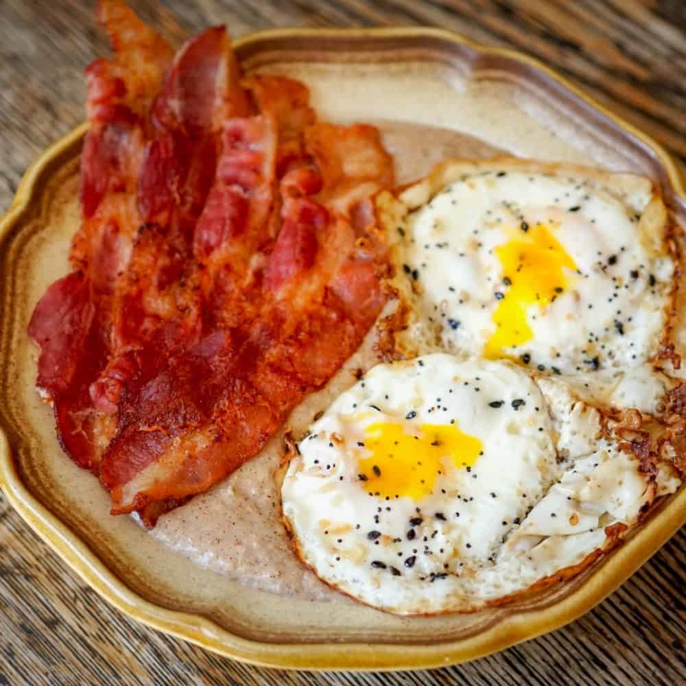 Cinnamon Roll Oats topped with Crispy Bacon & Runny Fried Eggs!